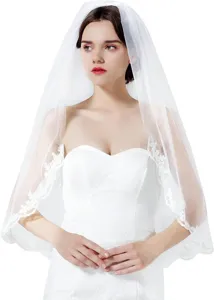 Elegant white bridal veil with delicate lace edge, perfect wedding accessory for brides.