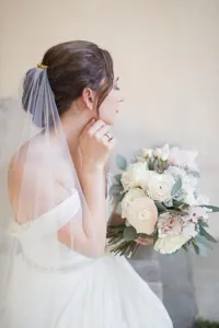 Elegant long bridal veil with hair comb and cut edge, perfect for wedding ceremonies and photos.