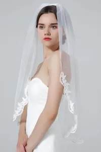 Elegant white bridal veil with delicate lace embroidery, perfect for wedding ceremonies.
