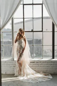 Lace bridal gown and veil detail shot, elegant indoor window backdrop, exquisite vibe.