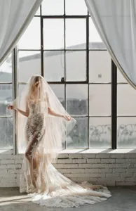 Detailed view of the elegant lace wedding veil and matching bridal gown for photography.
