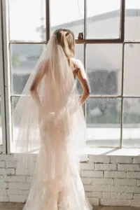 Elegant double layer bridal veil with comb, medium long tulle wedding hair accessory.
