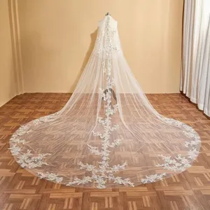 Lange kathedraal bruidssluier met glinsterende kantapplicaties en elegante sleep.