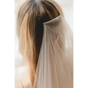 Elegant double layer bridal veil with comb for wedding photography and bridal wear elegance.