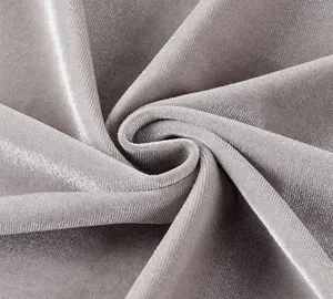 Close-up detail shot of soft grey velvet fabric, showing fine texture, rich nap and gentle sheen.
