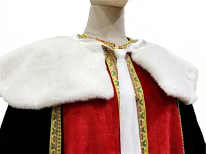 Detail of red black velvet cape with white fur collar and traditional ribbon trim for costume.