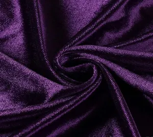 Purple velvet fabric detail close up showing soft texture and draping folds elegance.