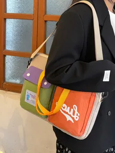 Colorblock canvas shoulder bag for women, casual daily crossbody handbag with large capacity.