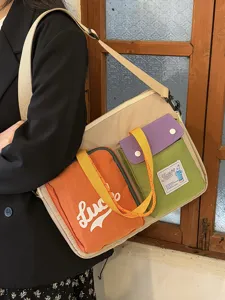 Korean niche color-blocked laptop bag, casual large-capacity shoulder bag with multiple pockets.