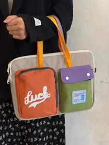Detailed view of color-blocked laptop shoulder bag with multi pockets and colorful straps