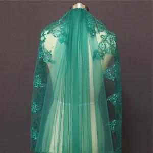 Dark green bridal veil detail, featuring delicate embroidered lace and shiny sequin accents.