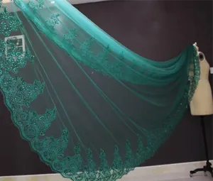 Detailed view of dark green bridal veil with exquisite lace embroidery and shiny sequins.