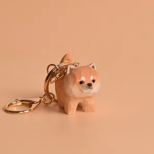 Wooden Shiba Inu keychain detail shot, cute carved animal pendant with gold metal ring.