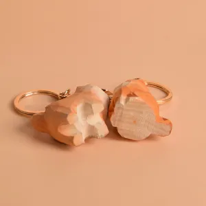 Wooden carved animal keychain detail view, cute cat or dog pendant, durable metal key ring.
