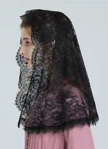 Close-up detail of the elegant black lace mantilla veil, showing fine floral embroidery texture.