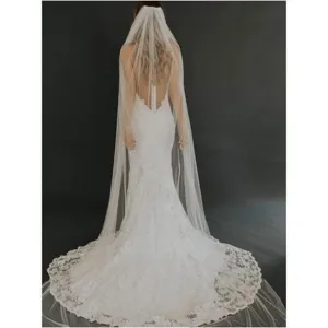 Long white bridal veil with delicate lace trim and comb, elegant wedding hair accessory for women.
