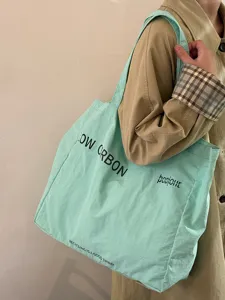 Light green canvas tote bag with letter print, large capacity casual shoulder bag for daily use.