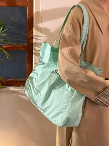 Light green canvas tote bag for women, large capacity casual shoulder bag with stylish print.