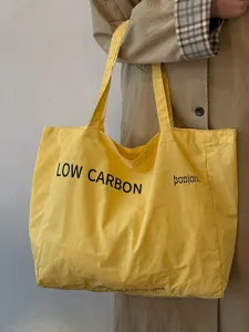Casual yellow canvas tote bag with large capacity, perfect for daily commuting and lazy style.