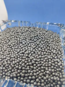 Detailed view of small steel balls and iron sand used for tripod counterweight filling.