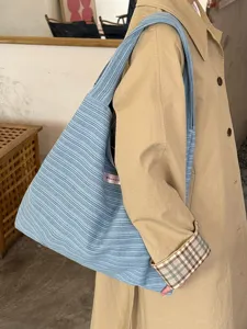 Detailed view of the casual striped canvas tote bag, featuring large capacity and stylish design.
