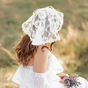 White lace bridal veil detail shot showing delicate floral embroidery and delicate texture.