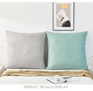 Detail view of simple soft throw pillow covers in grey and mint green for living room decor.