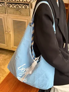 Casual light blue canvas shoulder bag featuring a cute lace bow, ideal for daily commuting use.
