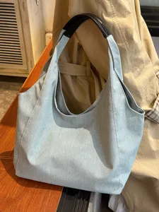 Casual light blue denim tote bag for women, large capacity shoulder bag for daily commute.