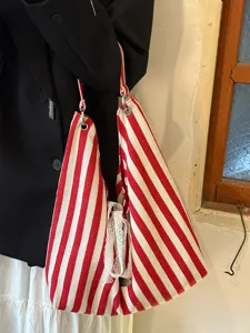 Red and white striped canvas bag detail view, large capacity shoulder tote, daily commute.