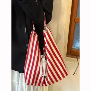 Korean style striped canvas shoulder bag, large capacity casual tote for daily commuting.