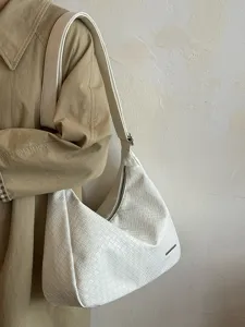 Nahaufnahme der weißen geflochtenen Leder-Umhängetasche mit Textur und Tragegurt.