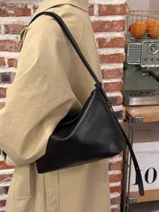 Minimalist black soft leather shoulder bag, chic underarm purse for women daily commute.