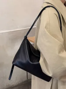 Minimalist black soft leather shoulder bag for women, chic underarm tote for daily commute.