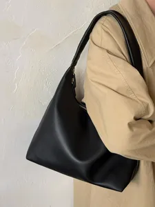 Minimalist soft leather shoulder bag for women, casual black hobo underarm bag detail.