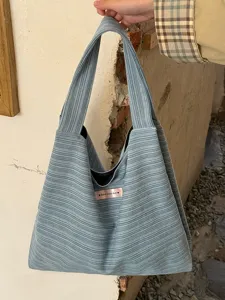 Detailed view of the blue striped canvas shoulder tote bag, large capacity design for daily use.