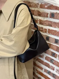 Minimalist black soft leather underarm shoulder bag, chic Korean style daily commuter purse.