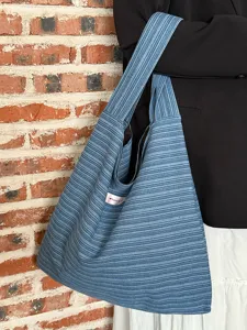 Blue striped knitted shoulder tote bag detail view, casual daily commuting style.