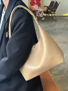 Close-up detail showing the texture of the stylish soft leather minimalist underarm bag.