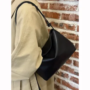 Minimalist black soft leather underarm bag for women, chic vintage style single shoulder handbag.