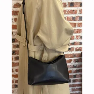 Black soft leather shoulder bag for women, minimalist underarm crossbody bag for daily commute.