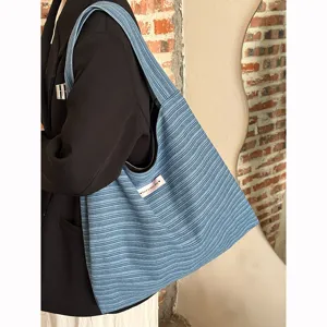 Casual striped knit shoulder bag for women, large capacity daily tote and commute bag.