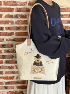 Detailed view of the cute puppy print canvas tote bag with polka dots and comfortable straps.