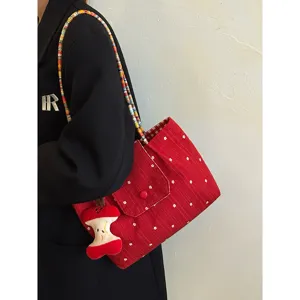 Korean style red canvas tote bag with colorful woven strap and cute apple pendant for women.