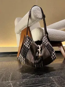 Detail view of Korean retro patchwork plaid canvas shoulder bag in casual daily style.