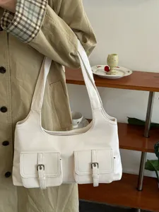 White multi-pocket shoulder bag detail, casual utility underarm bag with buckle closure.