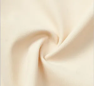 Close-up detail of soft beige fabric texture showing fine ribbed patterns and gentle folds.