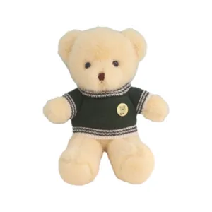 Cute stuffed teddy bear plush toy wearing a green knitted sweater, soft huggable doll gift.
