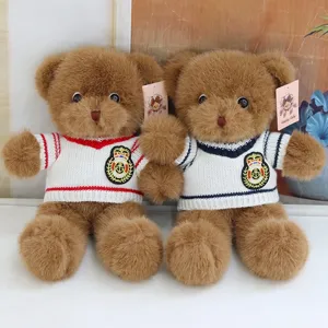Detailed shot of cute stuffed teddy bear plush toys wearing knit sweaters, soft.