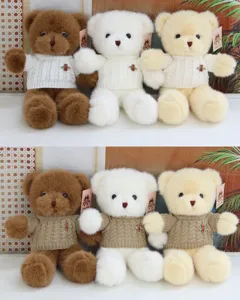 Plush teddy bear doll detail view, soft knitted sweater with cute bee brooch, fluffy toy gift.